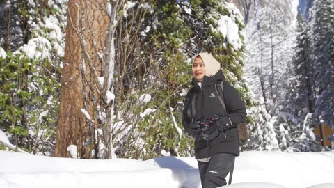 Young moslem explorer  enjoying the view of the tall evergreen trees  Video stock 127613090