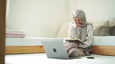 Young moslem women learn study write book online laptop remote work from home Stock Footage 299179733
