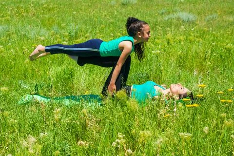 Young mother and daughter doing yoga exercises Stock-Fotos