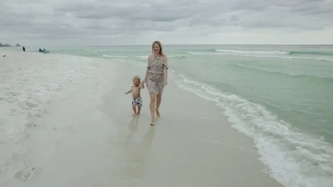 Young Mother and Her Son Walking on the Beach Along the Seashore USA 4k Stock Footage 81008665