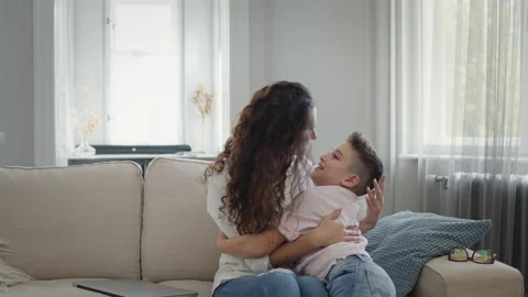 Young Mother And Son On The Couch. Mom Hugs The Boy. They Have Fun. Stock Footage 146402550