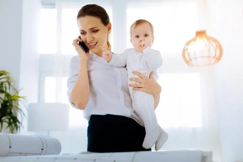 Young mother being involved in work Stock Photos