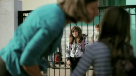 A young mother brings her child to school Stock Footage