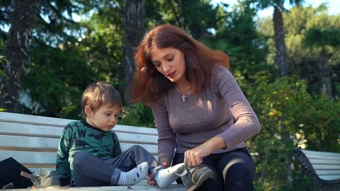 Young mother changes clothes to her little two-year-old son Video stock 118549573