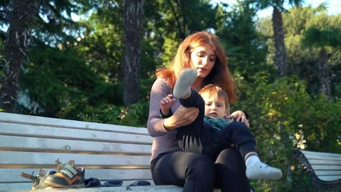 Young mother changes clothes to her little two-year-old son Video stock 118674770