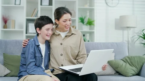 Young mother communicates with her son on a video call online using a laptop  Stock Footage 238628991