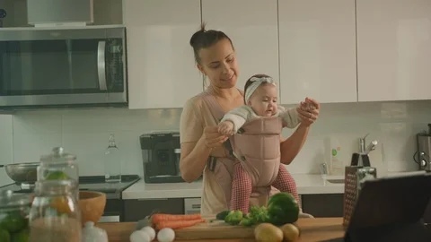 Young mother cook dinner with her little daughter, maternity leave Stock Footage 126358907