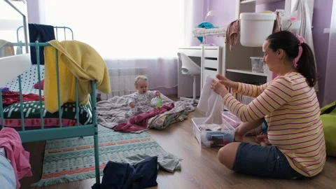 Young mother doing housework while baby playing Vídeos de archivo 247463397