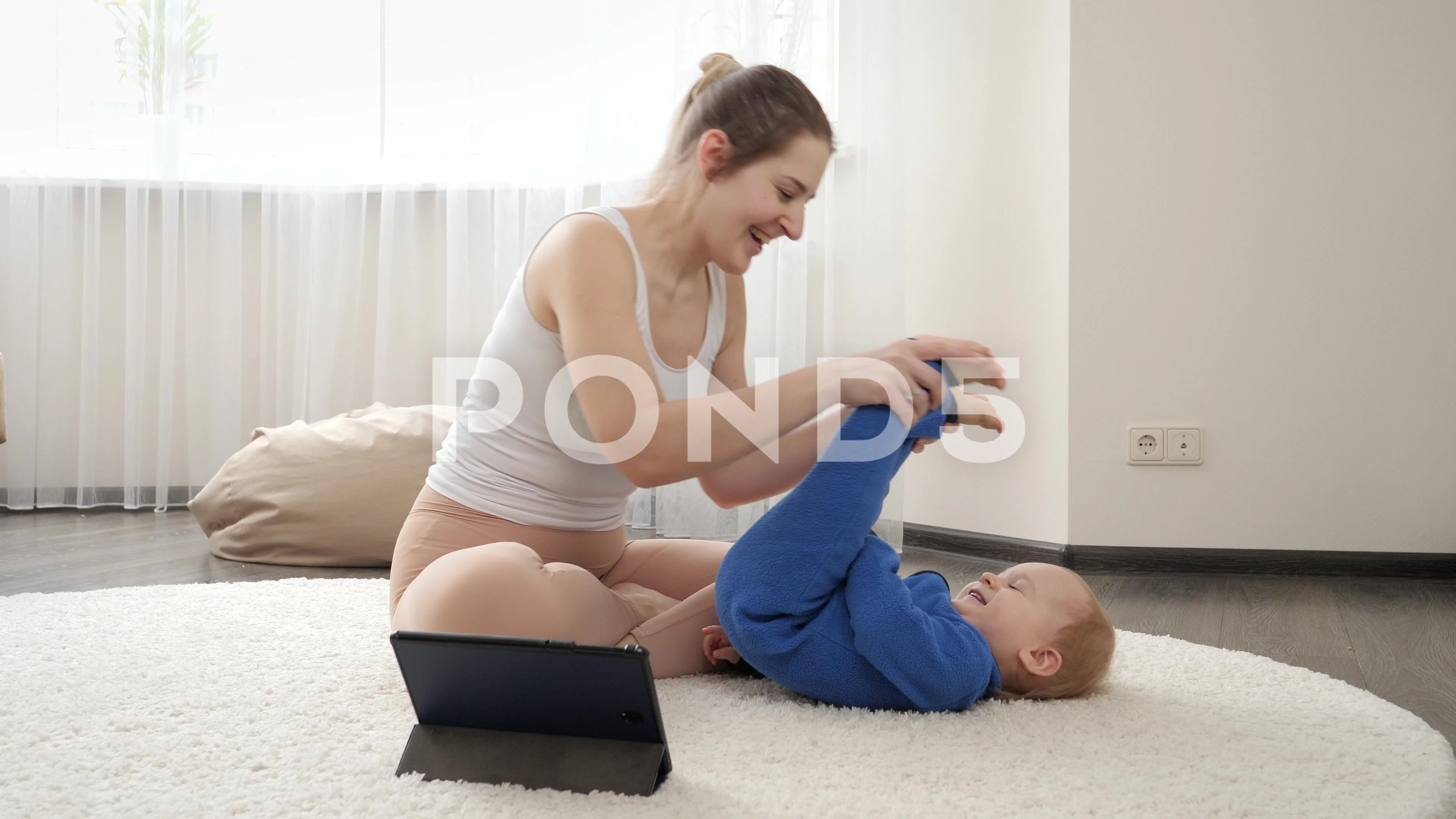 Young mother dwatching online video cour... | Stock Video | Pond5