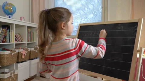 Young mother explaining arithmetic to cute little daughter at home Stock Footage 85838904
