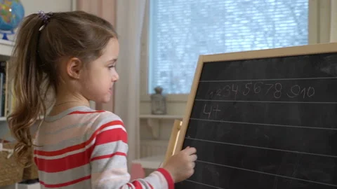Young mother explaining arithmetic to cute little daughter at home Stock Footage 85839427