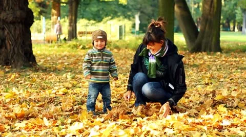 Young mother having fun with her son in autumn park, slow motion Video stock 8950962