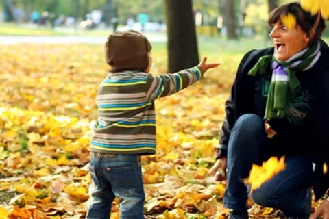 Young mother having fun with her son in autumn park, slow motion Stock Footage 8950998