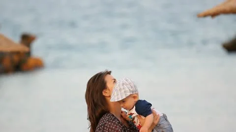 Young mother having fun with her baby at the seaside Stock Footage 12270946