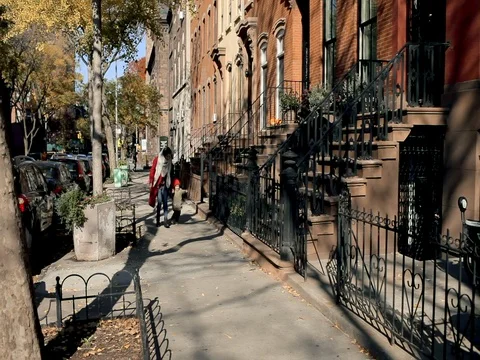 Young mother having fun with her kid son in autumn street New York Stock Footage 74006597