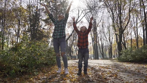 Young mother having fun with her son in autumn park at sunny day Video stock 97145893