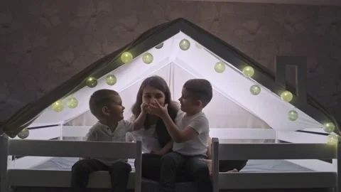 A young mother is having fun playing with her young sons in the house. Stock Footage 169471799