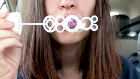 Young mother is having fun with soap bubbles. Stockbeeldmateriaal 186582048