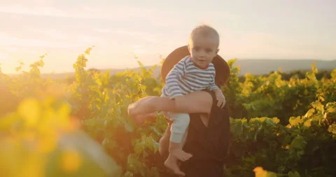 Young mother having fun time with her little baby boy in summer vineyard of 動画素材 203839834