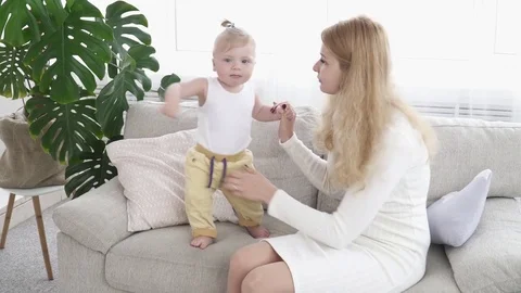 Young mother helping her small son walk Stock Footage 73628890