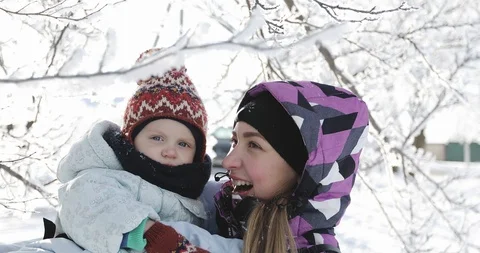 Young mother with her son having fun in the park in winter. Stock Footage 85879944