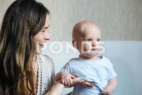 Young mother looks at baby Stock Photos