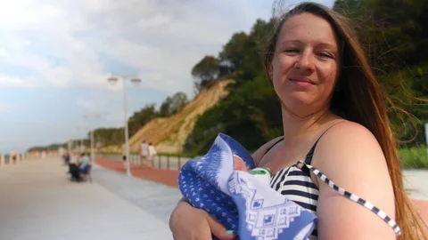 Young mother is lulling her little child holding him in arms. Family, motherhood Stock Footage 116402753