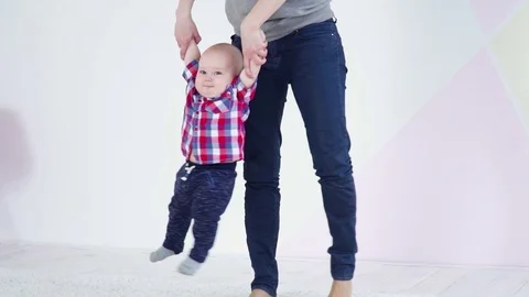 Young mother making exercises with her 6 months baby boy slow motion Stock Footage 75020484