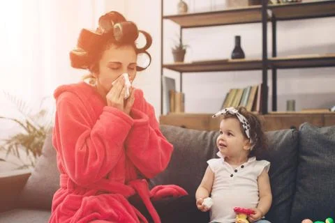 Young mother old is experiencing postnatal depression. Sad and tired woman with Stock Photos
