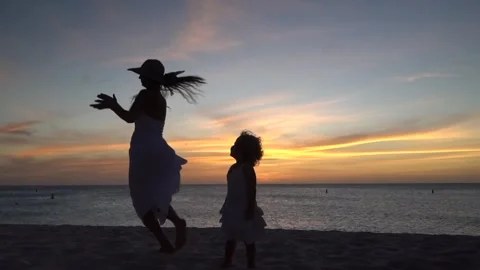 Young mother playing and dancing with his toddler daughter in Caribbean beach on Stock Footage 240204479