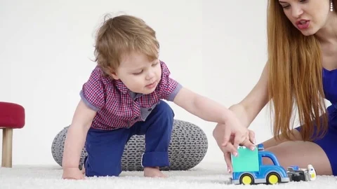 Young mother playing with her small son with the cars slow motion Stock Footage 74632871
