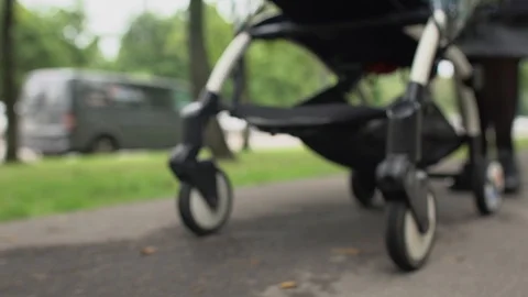 Young Mother Pushing Pram Stock Footage 125643333