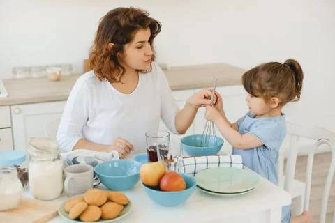 A young mother spends time with her little daughter at home. Stock Photos