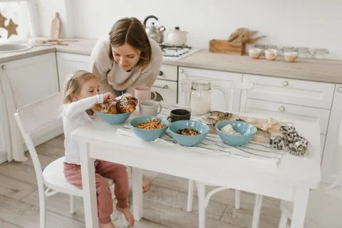 A young mother spends time with her little daughter at home. Stock Photos