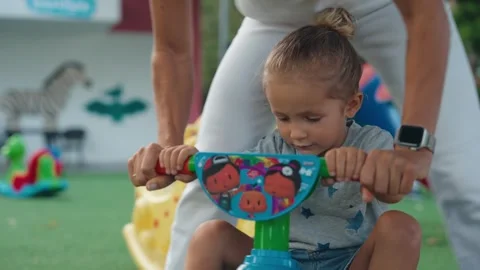 Young mother supporting her son on the playground. Children playing outdoor Video stock 254781801