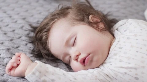 Young mother taking care of her little baby girl while she sleep Stock Footage 79900246