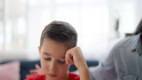 Young mother talking with upset son about problems in school, bullying victim Stock Footage 224957854