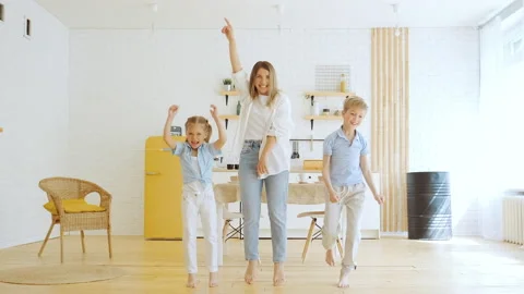 Young mother with two children dancing and having fun at home in living room Stock-Footage 194670609