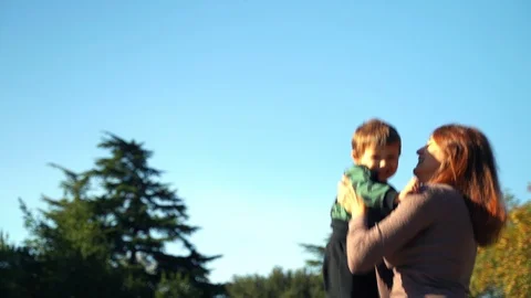 A young mother with a two year old son walks in the city. Sunny warm day in the Stock Footage 118674643