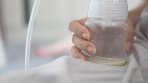 Young mother using electric breast pump ... | Stock Video