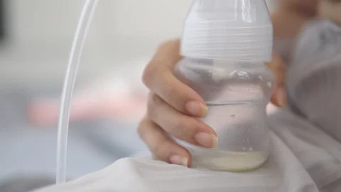 Young mother using electric breast pump pumping breast milk feeding for baby Video stock 109143232
