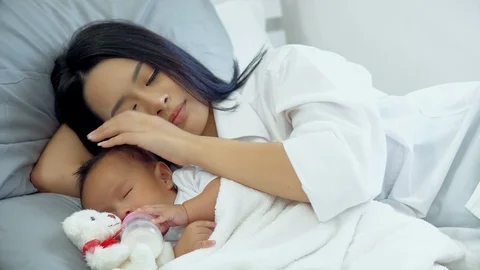 Young mother was soft touch on head baby during asleep Stock Footage 88265833