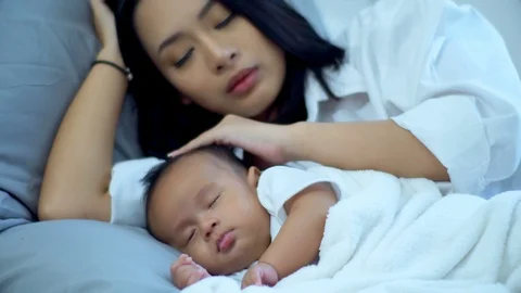Young mother was soft touch on forehead baby during asleep Stock Footage 88265961