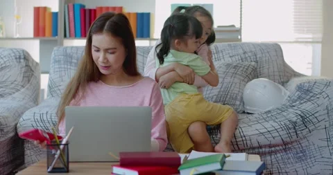 Young mother while working at home with two daughters naughty Stock Footage 138337088