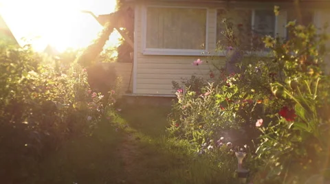 A young mother with a young son left the house to walk in the garden at sunset 스톡 동영상 67595027