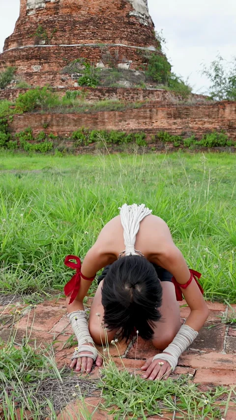 Young Muay Thai Fighter Performing Traditional Wai Khru Ritual at Ancient Temple Stock Footage 339823294