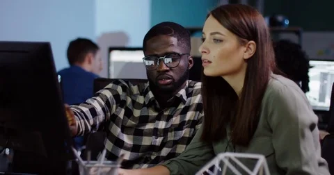 Young multi-ethnic couple of office workers doing a business project at the Stock Footage 82447559