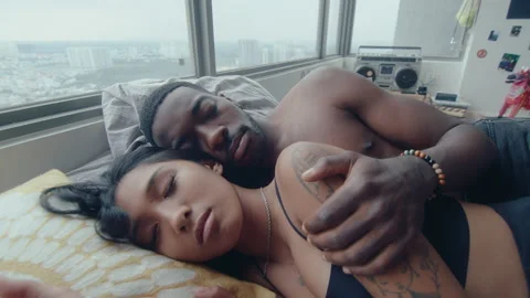 Young Multi-Ethnic Couple Sleeping and Cuddling in Bed Stock Footage 236685520