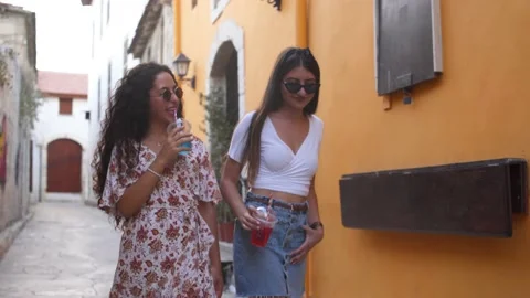 Young multi-ethnic friends having fun walking in old town streets Video stock 131473528