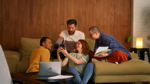 Young multi ethnic friends sit on sofa chatting Stock Footage 268203437